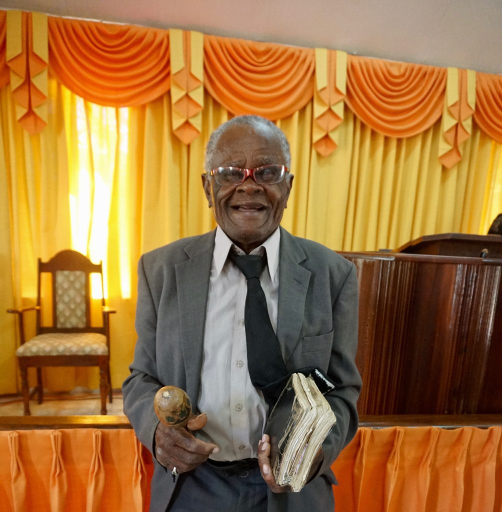 Angus all dressed up at church, with his well-worn Bible and his maraca.